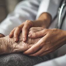 Caregiver comforting elderly person